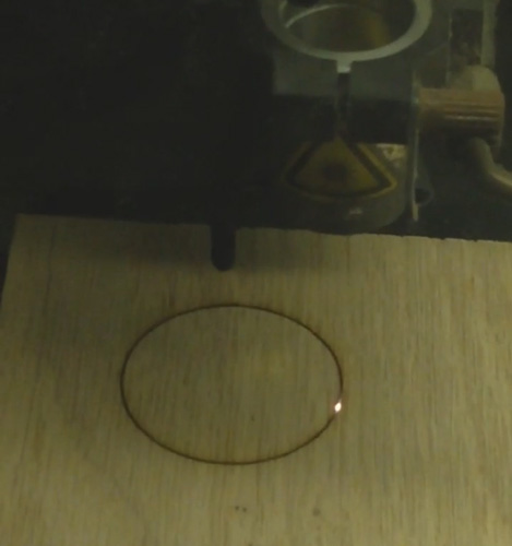 Screenshot from a video my friend sent me during his testing of cutting through oak plywood with his cnc laser.